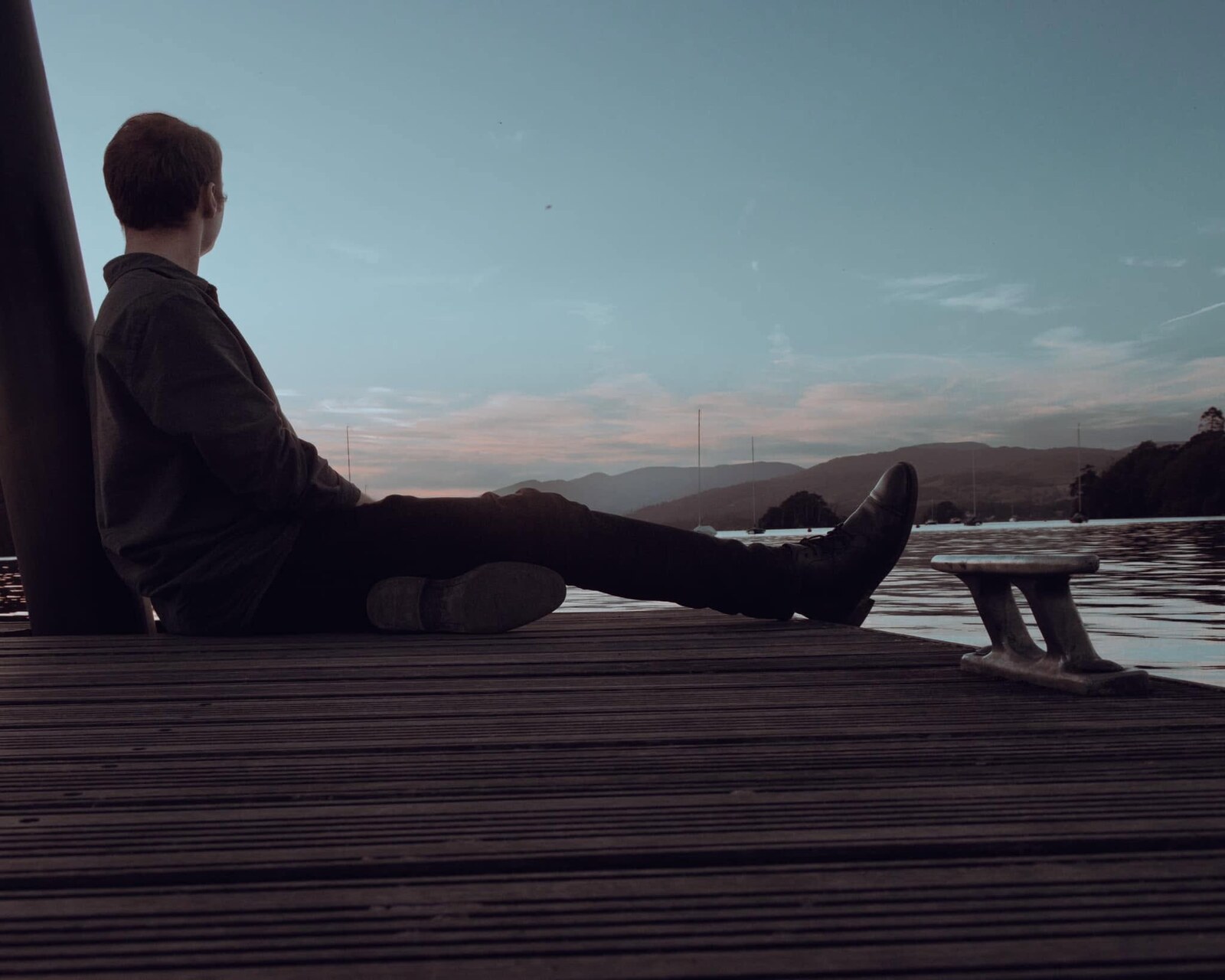 Jared Alexander seated on a dock overlooking the water